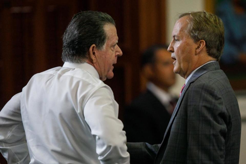 Texas Attorney General Ken Paxton, center, speaks with defense attorney Dan Cogdell before starting the ninth day of his impeachment trial in the Senate Chamber at the Texas Capitol on Friday, Sept. 15, 2023, in Austin.