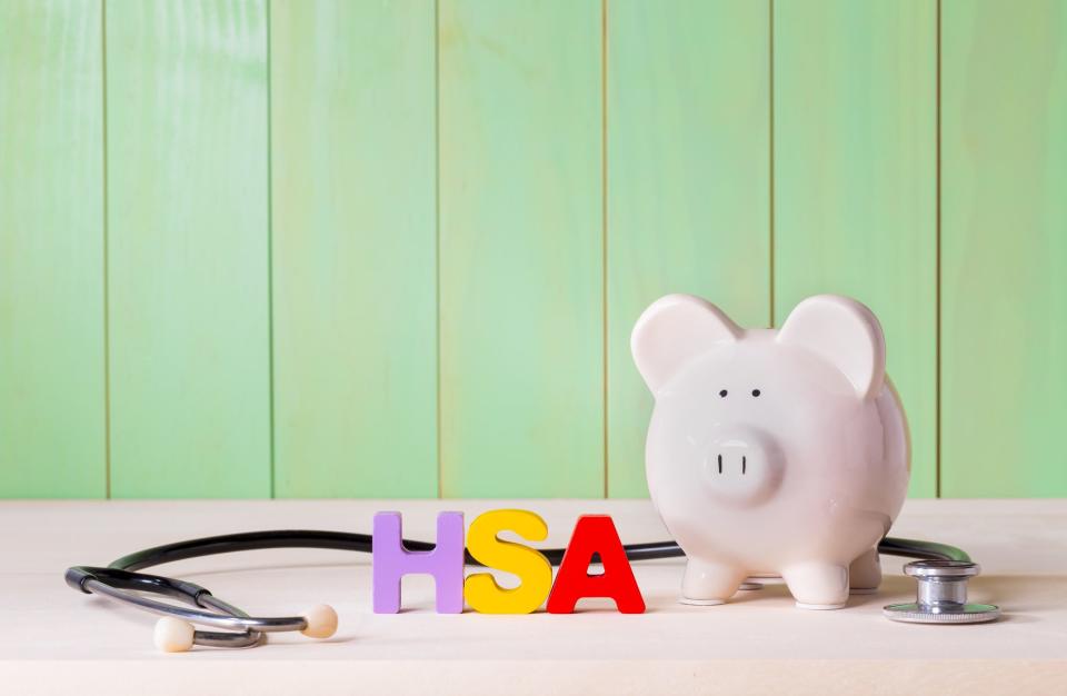 Piggy bank with HSA block letters next to it