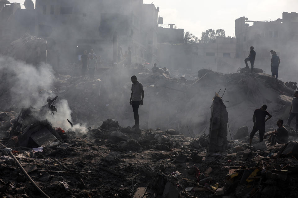 People check buildings destroyed in an Israeli strike on the Bureij refugee camp in the central Gaza Strip on November 2, 2023, as battles between Israel and the Palestinian Hamas movement continue.  (Photo by Majdi Fathi/NurPhoto via Getty Images)