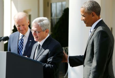U.S. President Barack Obama stands next to Judge Merrick Garland (C) of the United States Court of Appeals as his nominee for the U.S. Supreme Court as Vice President Joe Biden (L) joins in at the Rose Garden of the White House in Washington March 16, 2016. REUTERS/Jonathan Ernst