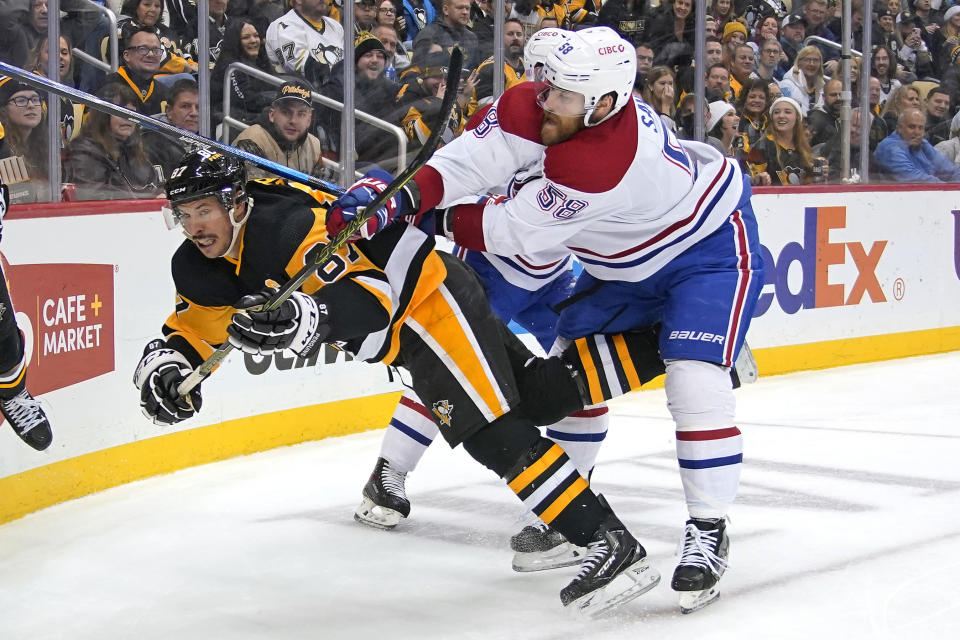 Pittsburgh Penguins' Sidney Crosby (87) is checked to the ice by Montreal Canadiens' David Savard (58) during the second period of an NHL hockey game in Pittsburgh, Saturday, Nov. 27, 2021. (AP Photo/Gene J. Puskar)