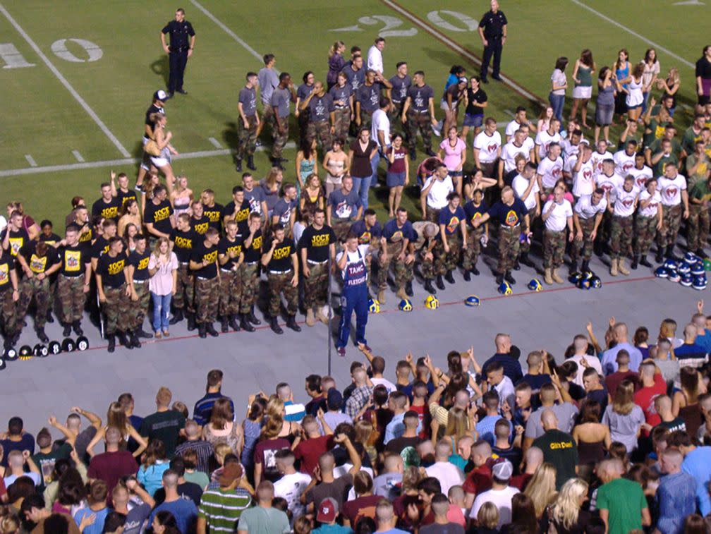 An Aggie Yell Leader signals for the Aggie War Hymn during a Midnight Yell Practice in 2007.