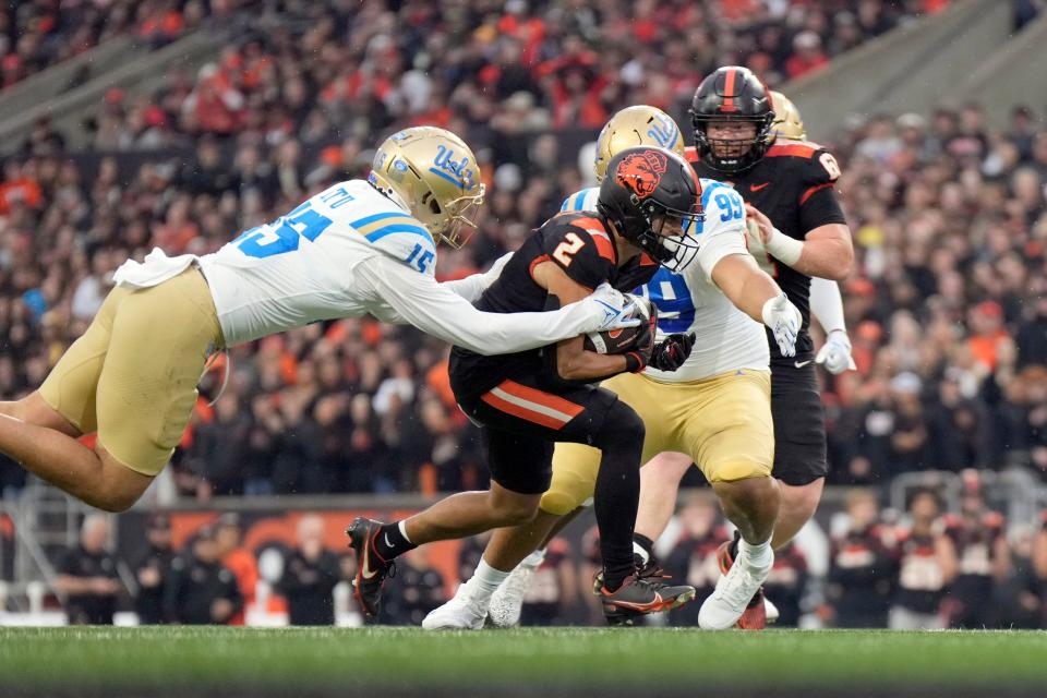 Oregon State wide receiver Anthony Gould (2) is swarmed by UCLA defenders during their game in Corvallis on Oct. 14.