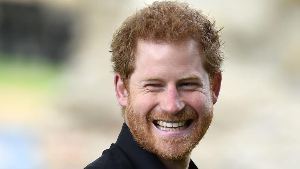 prince harry smiling in black shirt 