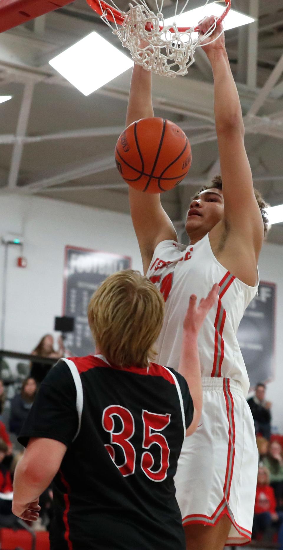 West Lafayette Red Devils center Kevo St. Hilaire (50) dunks over Rensselaer Central Bombers Graham Drone (35) during the IHSAA basketball doubleheader, Thursday, Jan. 11, 2024, at West Lafayette High School in West Lafayette, Ind.