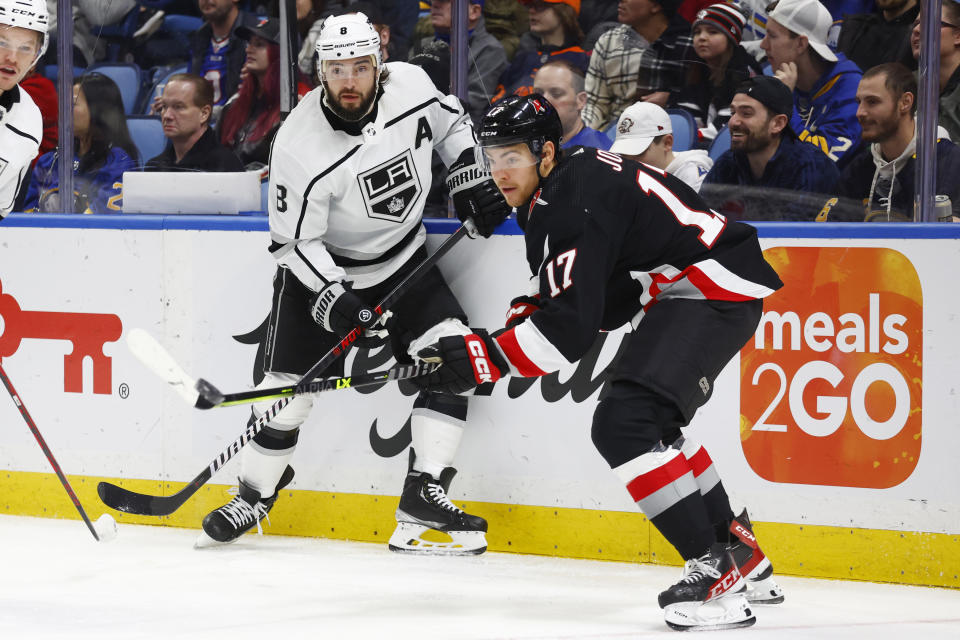 Los Angeles Kings defenseman Drew Doughty (8) passes the puck past Buffalo Sabres center Tyson Jost (17) during the first period of an NHL hockey game, Tuesday, Dec. 13, 2022, in Buffalo, N.Y. (AP Photo/Jeffrey T. Barnes)