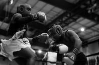 <p>Dwayne Leeshue, left, follows through on a punch against the NYPD’s Billy Ramirez during the “Bronx Tough Turkey Tussle” at the New York Expo Center in the Bronx, New York, on Nov. 16, 2017. (Photo: Gordon Donovan/Yahoo News) </p>