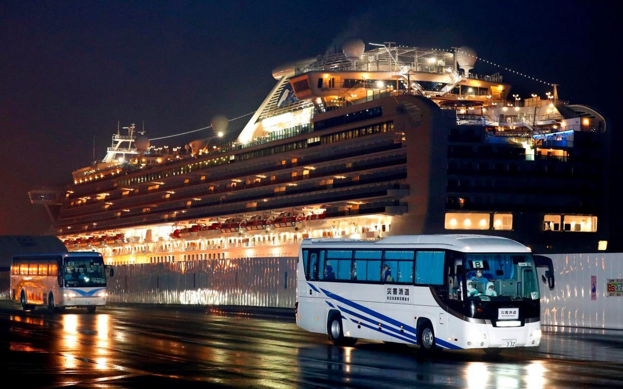 Buses carrying U.S. passengers who were aboard the quarantined cruise ship the Diamond Princess, leaves Yokohama port, near Tokyo, early Monday - Jun Hirata / Kyodo News