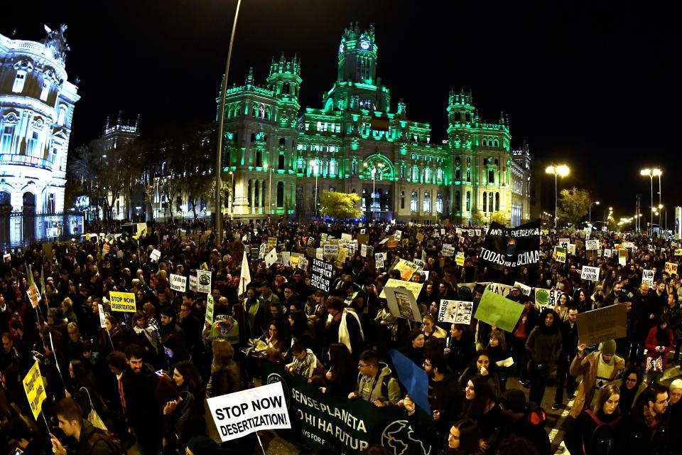 Demonstrators walk past the city hall on Cibeles Square during a mass climate march to demand urgent action on the climate crisis from world leaders attending the COP25 summit in Madrid on Friday. (Photo: OSCAR DEL POZO via Getty Images)