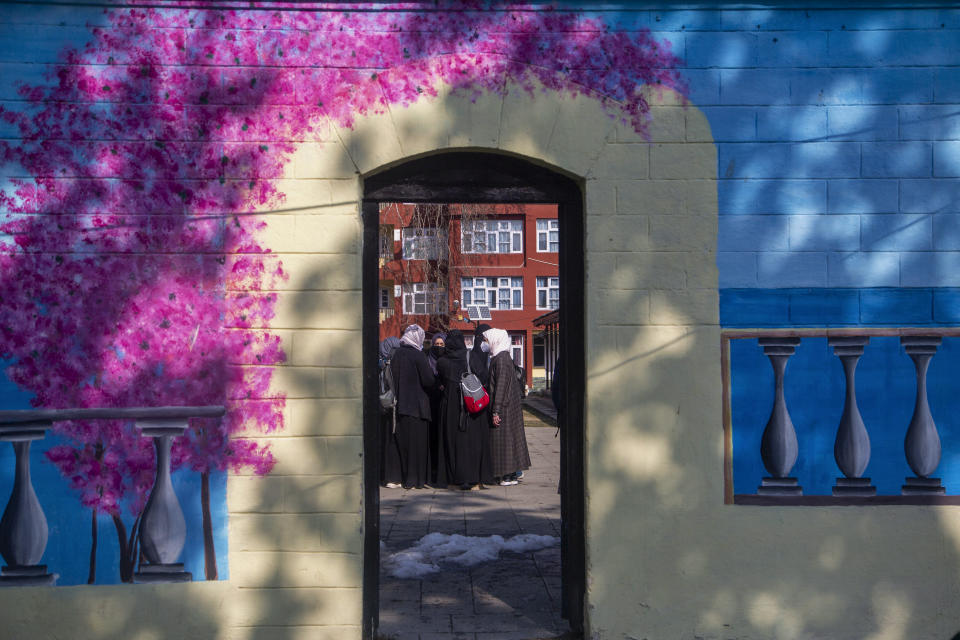 Kashmiri students assemble inside their campus as colleges reopened eleven months after being closed due to the coronavirus pandemic in Srinagar, Indian controlled Kashmir, Monday, Feb. 15, 2021. (AP Photo/Mukhtar Khan)