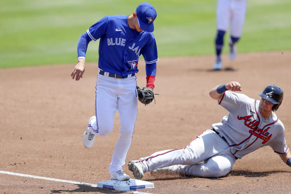 Toronto Blue Jays third baseman Cavan Biggio forces out Atlanta Braves' Austin Riley during the second inning of a baseball game Sunday, May 2, 2021, in Dunedin, Fla. (AP Photo/Mike Carlson)
