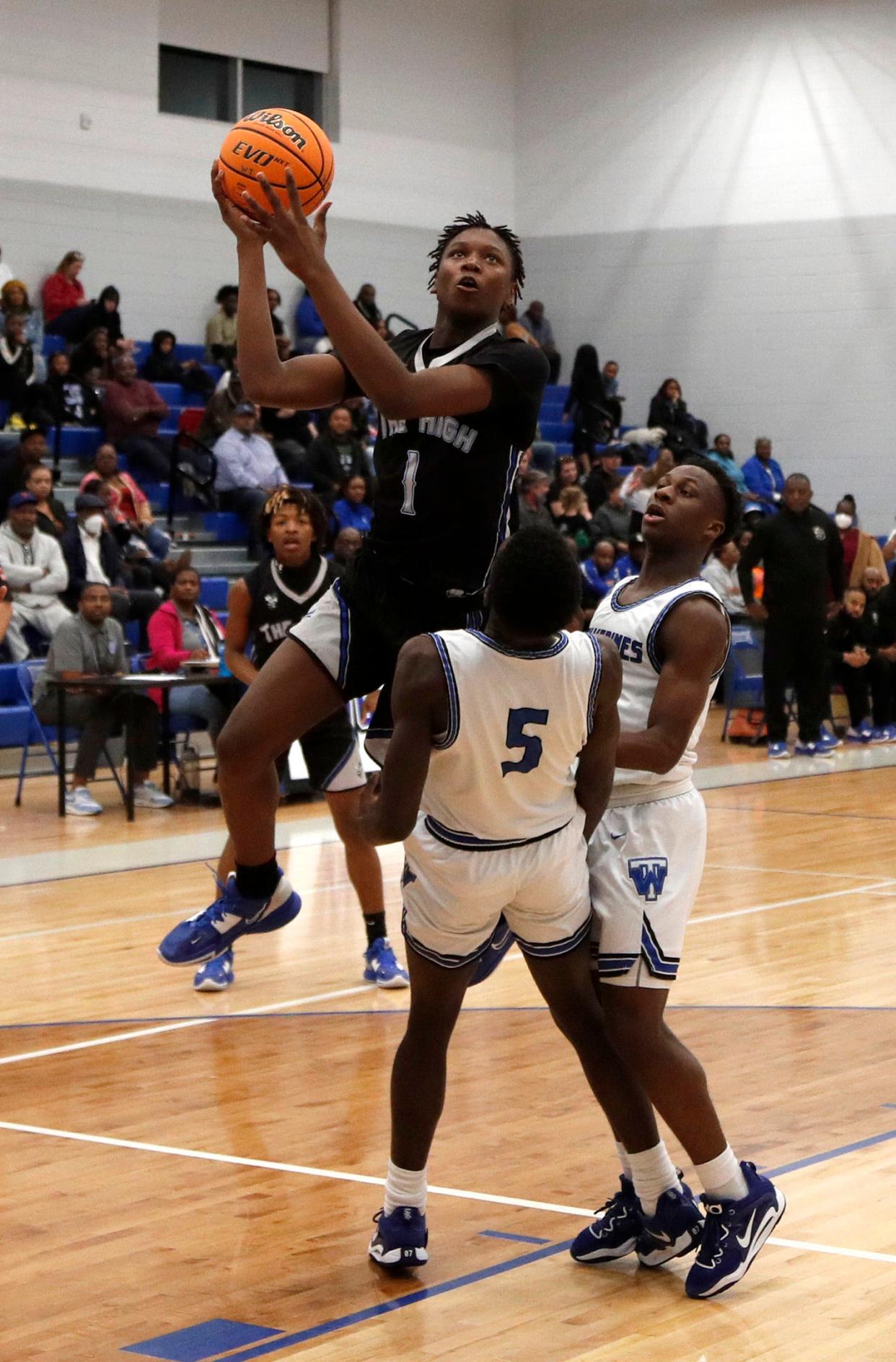 Savannah High's Maki Joyner attempts to go up for a basket over Woodville-Tompkins' Tyler Grant Friday night during the Region 3-A Div.1 title game.