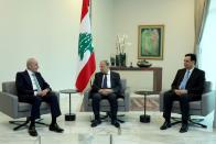 Lebanon's President Michel Aoun meets with Prime Minister Hassan Diab and Parliament Speaker Nabih Berri at the presidential palace in Baabda