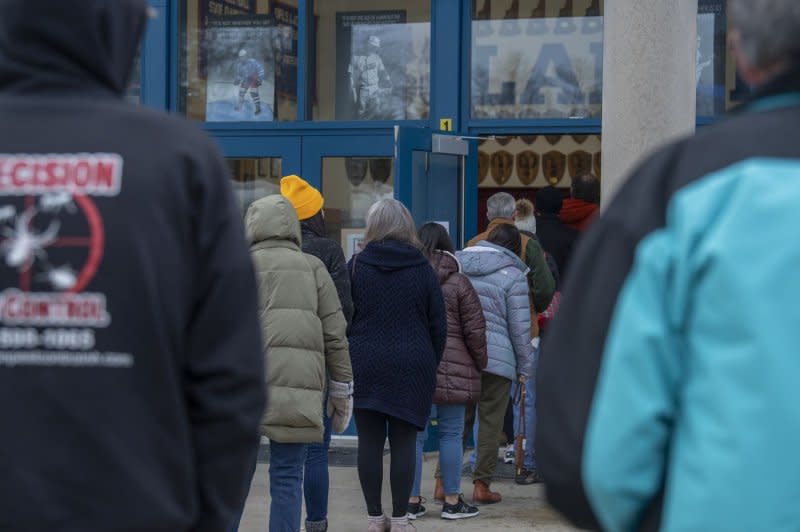 People wait in line to vote in the New Hampshire Primary at Londonderry High School, the state's largest polling location, in Londonderry, N.H., on Tuesday. Photo by Amanda Sabga/UPI