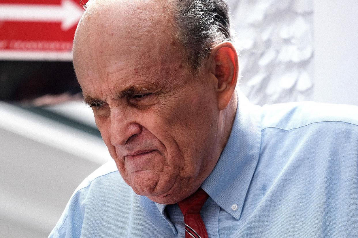 A close-up of Rudy Giuliani's face, which is contorted into an expression of disappointment or consternation.