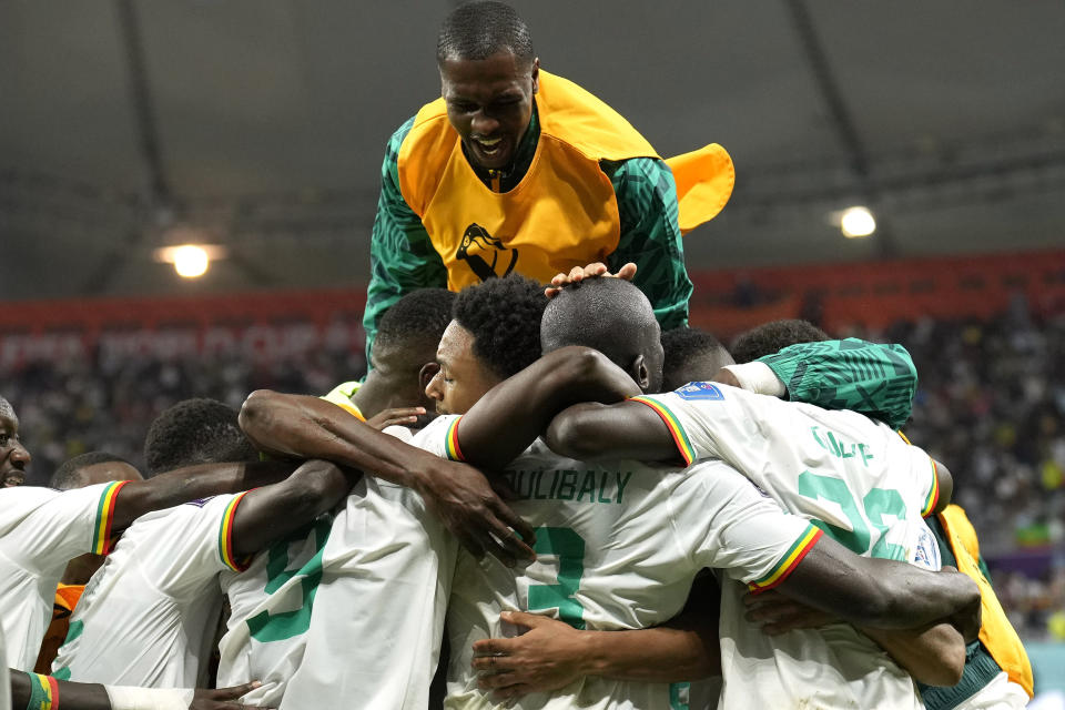 Senegal players celebrate scoring their side's second goal during the World Cup group A soccer match between Ecuador and Senegal, at the Khalifa International Stadium in Doha, Qatar, Tuesday, Nov. 29, 2022. (AP Photo/Francisco Seco)