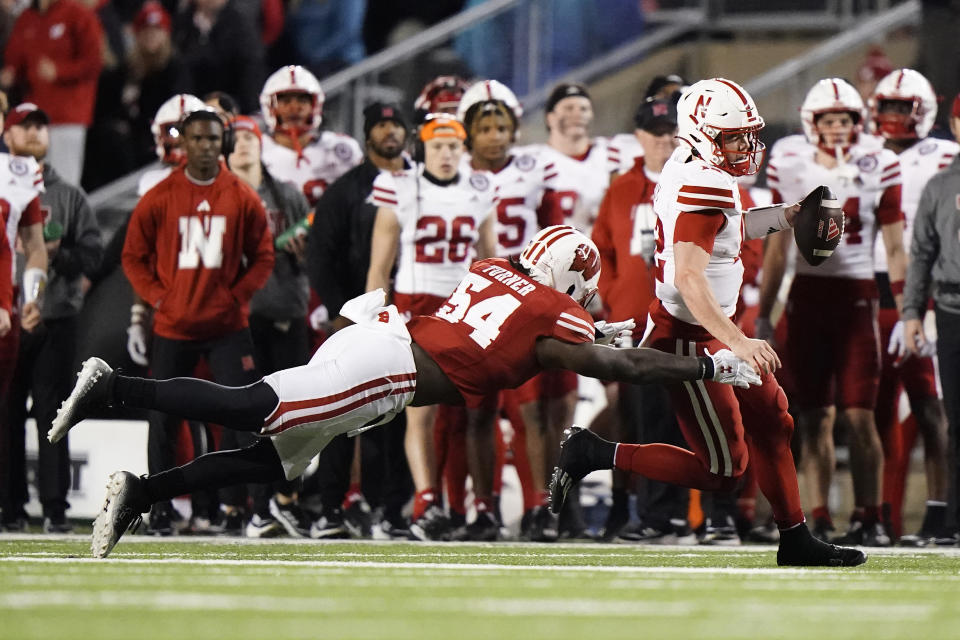 Nebraska's Chubba Purdy runs against a diving Wisconsin's Jordan Turner (54) during the second half of an NCAA college football game Saturday, Nov. 18, 2023 in Madison, Wis. (AP Photo/Aaron Gash)