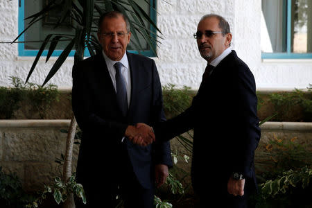 Russian Foreign Minister Sergei Lavrov shakes hands with Jordan's Foreign Minister Ayman Safadi in Amman, Jordan September 11, 2017. REUTERS/Muhammad Hamed