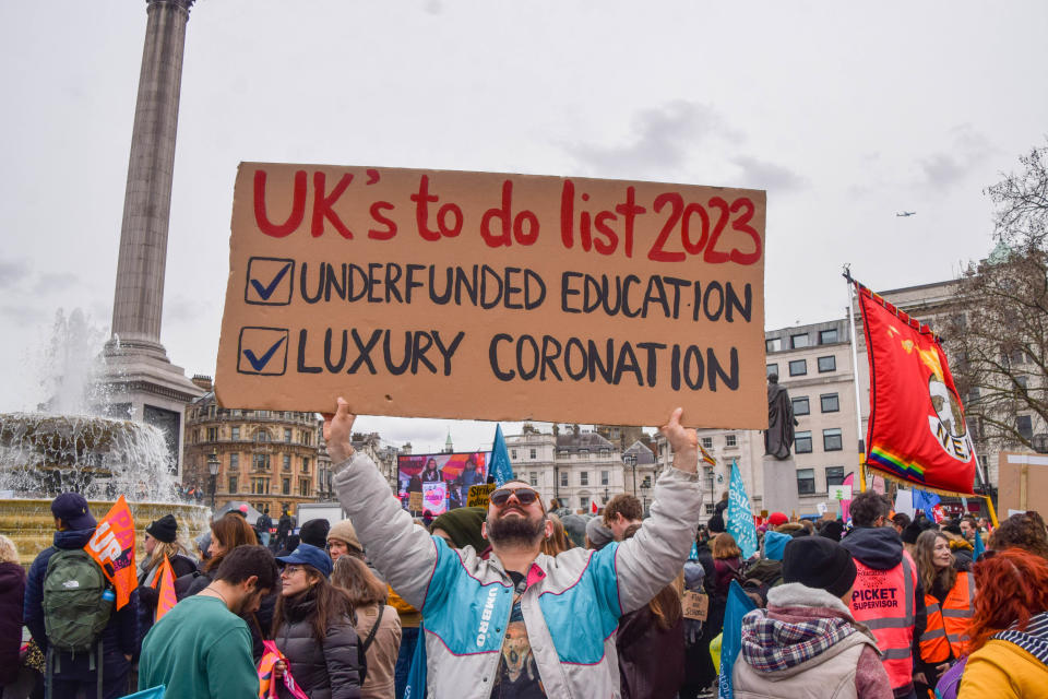 A protester holds a placard which states 'The UK's to-do list (Vuk Valcic / SOPA via Getty Images)
