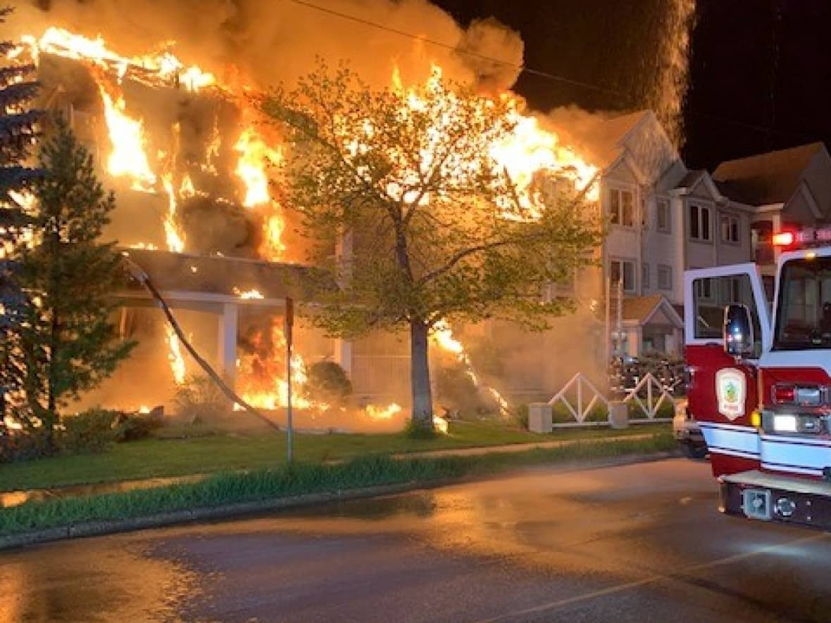 The Saskatoon Fire Department said crews arrived to the 300 block of 108th Street W. around midnight on Saturday. They were still fighting an out-of-control fire more than an hour later. (Saskatoon Fire Department - image credit)