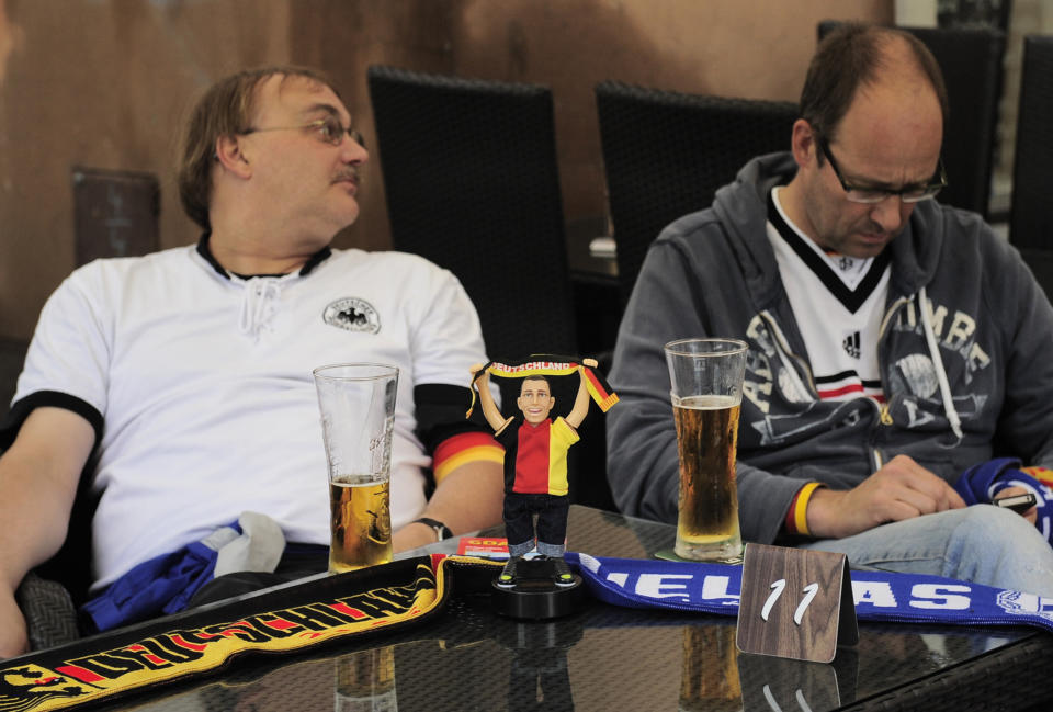 German fans rest in a bar before the Euro 2012 soccer championship quarterfinal match between Germany and Greece in Gdansk, Poland, Friday, June 22, 2012. (AP Photo/Alvaro Barrientos)