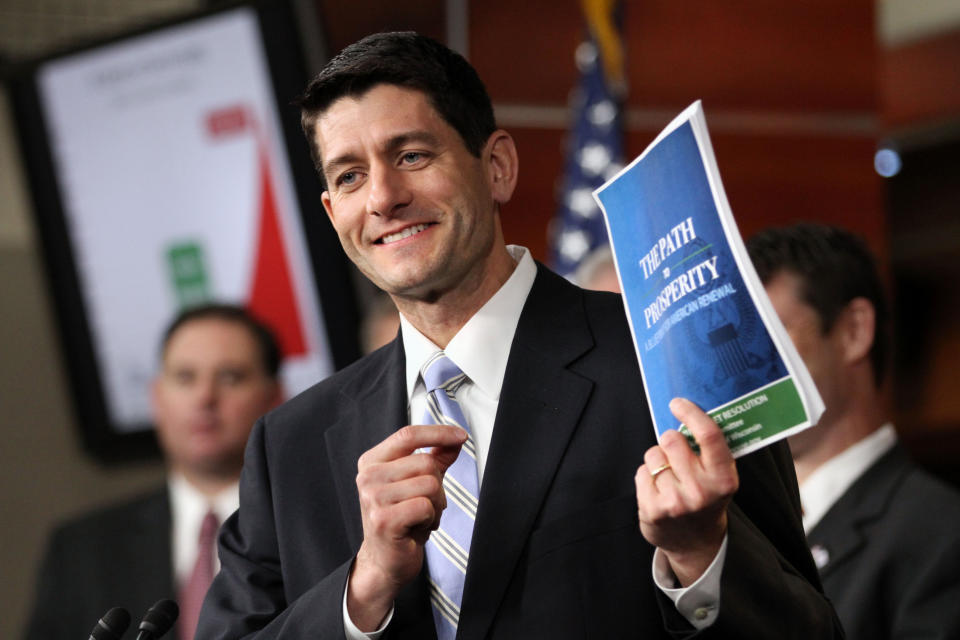 House Budget Committee Chairman Rep. Paul Ryan, R-Wis., center, holds up a copy of his budget plan, entitled "The Path to Prosperity," Tuesday, March 20, 2012, during a news conference on Capitol Hill in Washington. (AP Photo/Jacquelyn Martin)