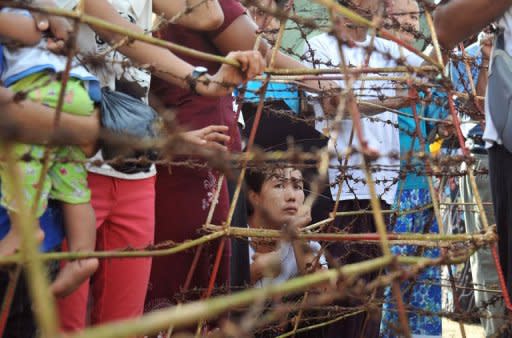 Family members of prisoners wait for their release outside the Insein central prison in Yangon on October 12. Myanmar faced calls on Thursday to free its remaining political prisoners as the opposition expressed disappointment with a much-anticipated amnesty that left most key dissidents behind bars