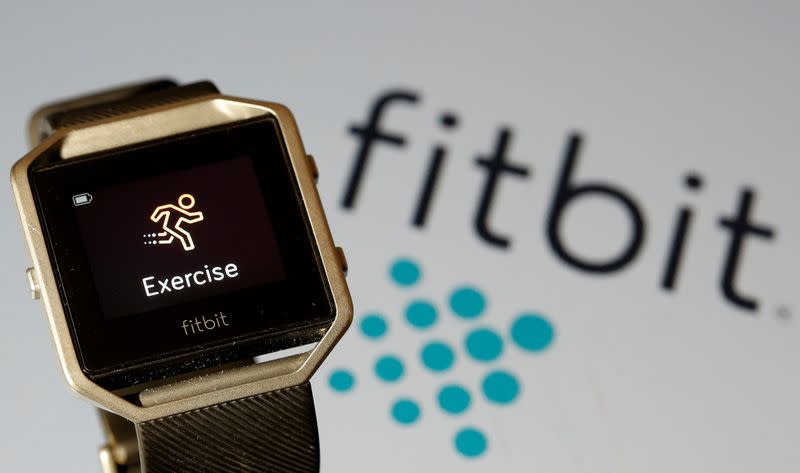 FILE PHOTO: Fitbit Blaze watch is seen in front of a displayed Fitbit logo in this illustration