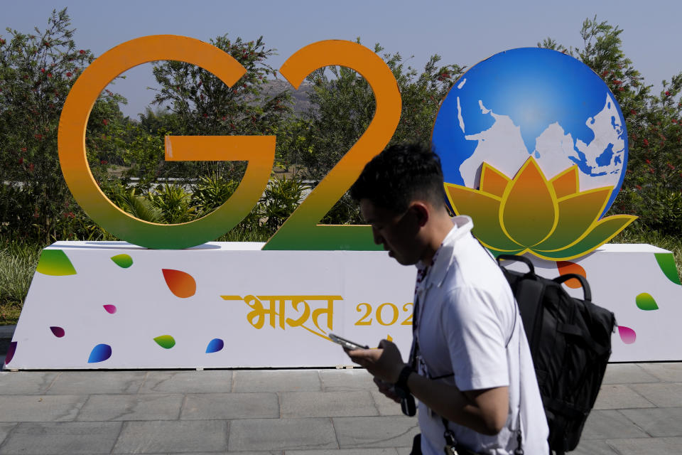 A man walks past G-20 signage at the venue of the G-20 financial conclave on the outskirts of Bengaluru, India, Wednesday, Feb. 22, 2023. Top financial leaders from the Group of 20 leading economies are gathering in the south Indian technology hub of Bengaluru to tackle challenges to global growth and stability. India is hosting the conclave for the first time in 20 years. (AP Photo/Aijaz Rahi)