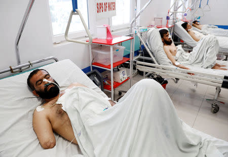 An Afghan man who was injured in Ghazni province attack receives treatment at a hospital in Kabul, Afghanistan August 18, 2018. REUTERS/Mohammad Ismail