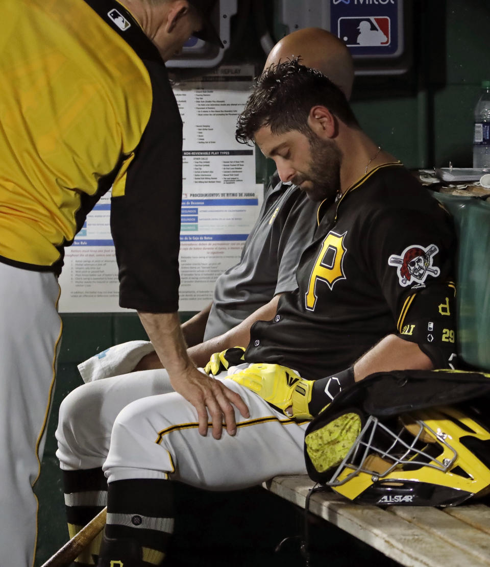 FILE - In this May 25, 2019, file photo, Pittsburgh Pirates catcher Francisco Cervelli is consoled by hitting coach Rick Eckstein, left, after taking himself out of a baseball game against the Los Angeles Dodgers during the fourth inning in Pittsburgh, after being hit in the head by a foul tip earlier in the inning. The Pirates are parting ways with veteran catcher Francisco Cervelli, who has been hampered by multiple concussions this season. The club announced Thursday, Aug. 22, 2019, it requested unconditional release waivers for the 33-year-old Cervelli. (AP Photo/Gene J. Puskar)