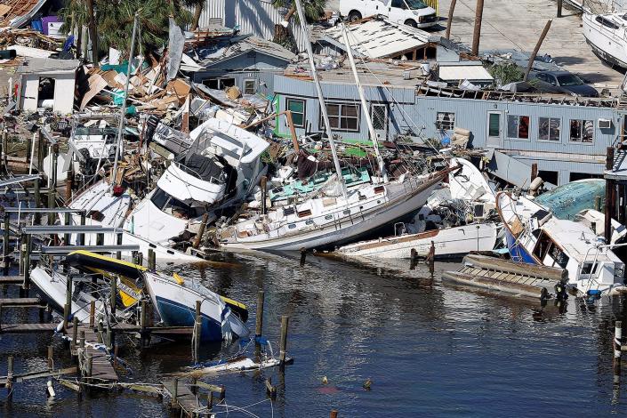 FORT MYERS BEACH, FLORIDA - SEPTEMBER 29: In an aerial view, boats are piled on top of each other after Hurricane Ian passed through the area on September 29, 2022 in Fort Myers Beach, Florida. The hurricane brought high winds, storm surge and rain to the area causing severe damage. (Photo by Joe Raedle/Getty Images)