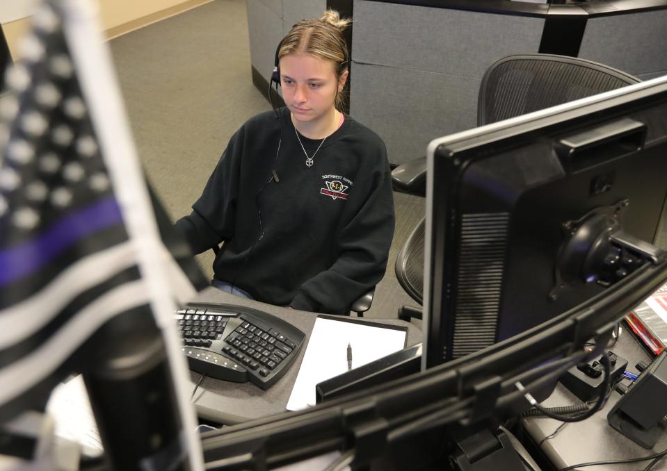 Madison Tatka, a dispatcher at the joint dispatching facility for Norton, Copley and Barberton, works at her desk.