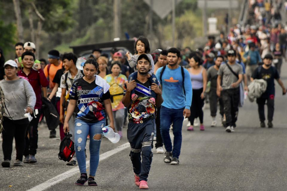 Migrants march to Huehuetan, Chiapas state, Mexico, Monday, April 24, 2023. About 3,000 migrants began walking before dawn for a second day of protest march demanding the end of detention centers like the one that caught fire last month, killing 40 migrants. (AP Photo/Edgar H. Clemente)