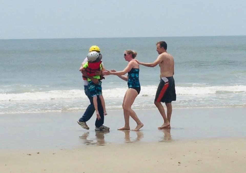 The boy is returned to his relieved mum and dad on the beach at Oak Island. 