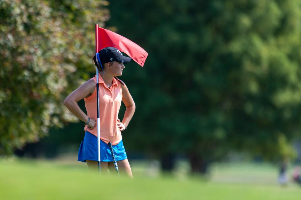 Memorial's Abigail Shires holds the flag during the 2024 Girl's Golf Sectional 23 at Fendrich Golf Course in Evansville, Ind., Saturday, Sept 21, 2024.