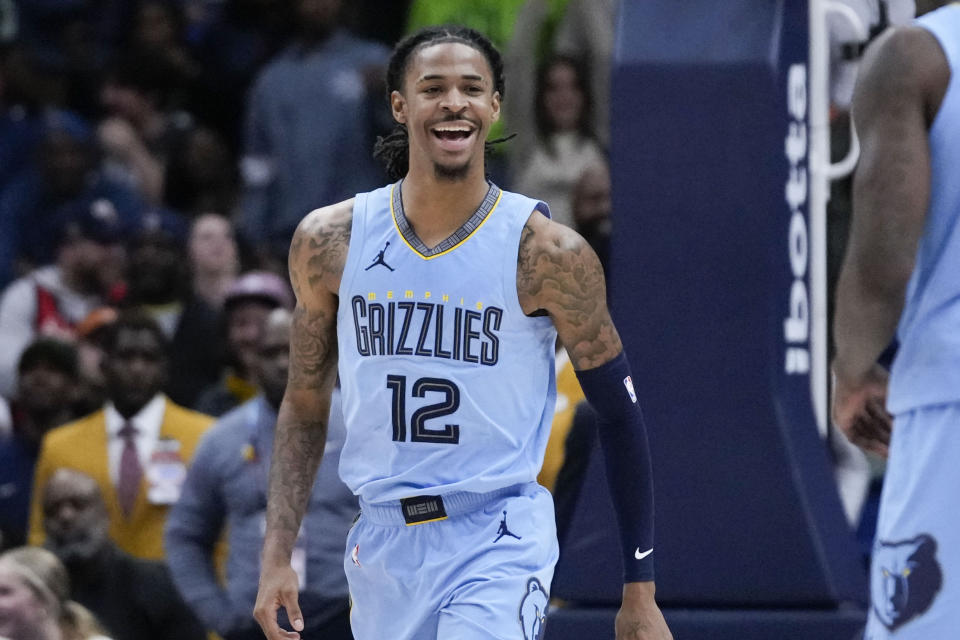 Memphis Grizzlies guard Ja Morant (12) reacts after his slam dunk in the final seconds of overtime during an NBA basketball game against the New Orleans Pelicans in New Orleans, Tuesday, Dec. 26, 2023. The Grizzlies won 116-115. (AP Photo/Gerald Herbert)