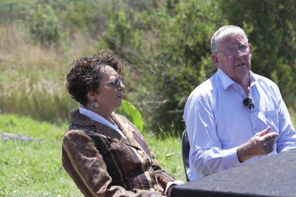 Aith Advocate Annade Thiart-Hofmeyr, left, who read the victim impact statement, listens to Rob Mathews, the Steenkamp family representative at the entrance of Atteridgeville Prison, where Oscar Pistorius is being held, following his parole hearing, in Pretoria, South Africa, Friday, Nov. 24, 2023. Pistorius has been granted parole, 10 years after shooting his girlfriend through a toilet door at his home in South Africa. Pistorius will be released from prison on Jan. 5, 2024. (AP Photo/ Tsvangirayi Mukwazhi)