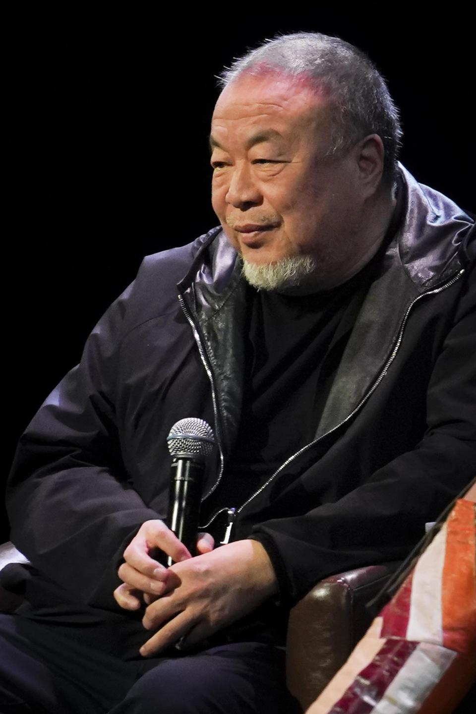 Visual artist and activist Ai Weiwei listens as he appears on stage with author Mira Jacob at The Town Hall theatre, Tuesday, Jan. 23, 2024, in New York. Ai was in New York to discuss his new book, the graphic memoir “Zodiac,” structured around the animals of the Chinese Zodiac, with additional references to cats. (AP Photo/Bebeto Matthews)