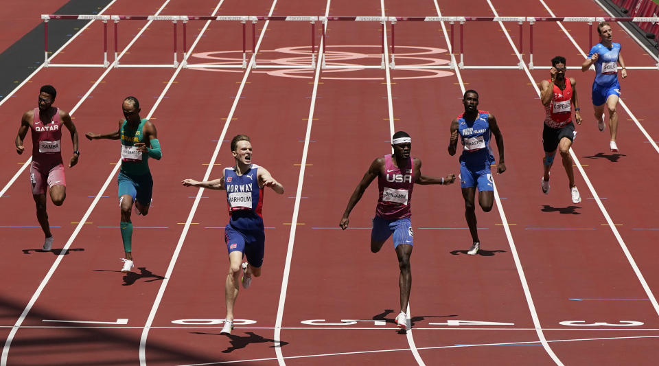 Karsten Warholm, of Norway, third left, celebrates as he wins the gold medal ahead of Rai Benjamin, of United States in the final of the men's 400-meter hurdles at the 2020 Summer Olympics, Tuesday, Aug. 3, 2021, in Tokyo, Japan. (AP Photo/Charlie Riedel)