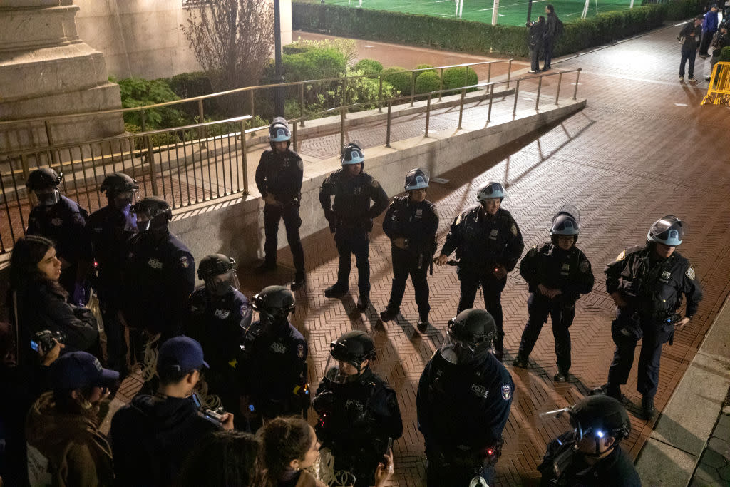  NYPD officers in riot gear enter Columbia University's encampment as they evict a building that had been barricaded by pro-Palestinian student protesters in New York City on April 30, 2024. 