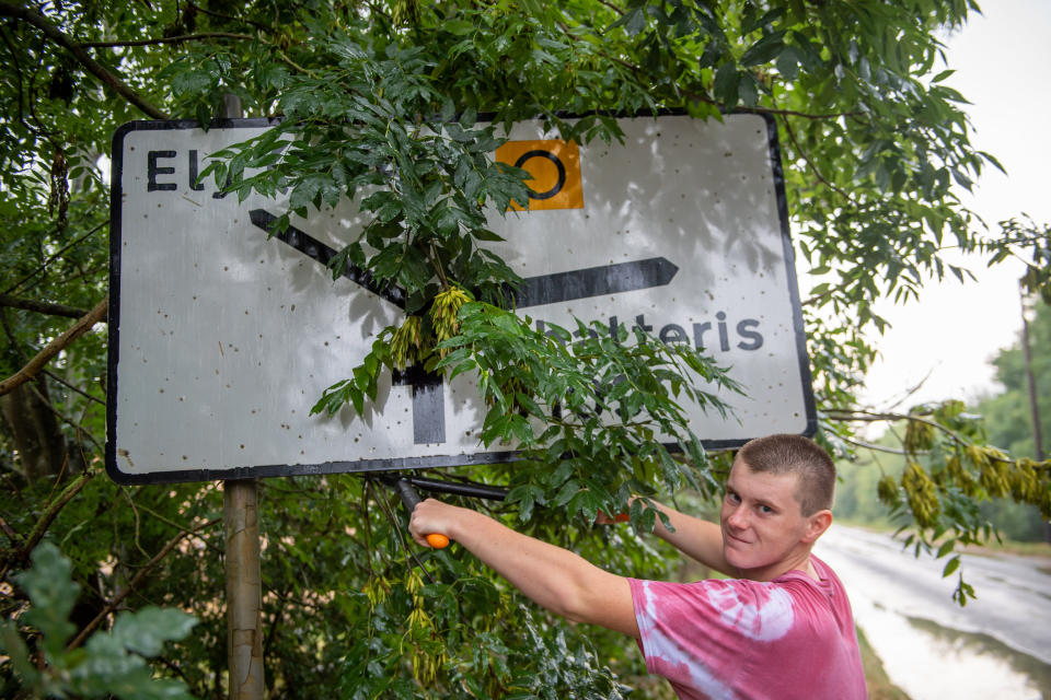 A teenage boy annoyed by road signs left dirty and hedges overgrown during lockdown has become a local hero after going on a mission to clean them all up. Joseph Beer, 15, noticed dozens of neglected street signs and hedgerows whilst out on his daily walks with mum Lisa, 52. He soon decided he wanted to clean up the streets - and with the help of dad Mark, 56, he rigged up a trailer to fix to the back of his bike, and started peddling around the streets near his house. Almost every day, Joseph, from Chatteris, Cambs., has headed off on his bike, towing a bucket of soapy water, some sponges, and garden tools, including hedgecutters and a rake, in the trailer.

His efforts have seen him clean up street name signs that have been left almost unreadable due to moss growing over them, such as Wilburton Road in nearby Ely.