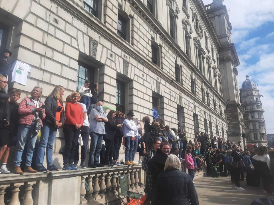 Mourners stood on walls and window sills in hope of getting a good view of the funeral procession (Zoe Tidman / The Independent)