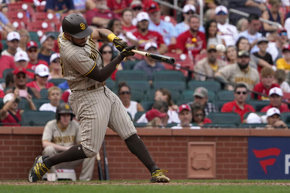 San Diego Padres' Tommy Pham hits a two-run double during the eighth inning of a baseball game against the St. Louis Cardinals Sunday, Sept. 19, 2021, in St. Louis. Pham went on to third on the throw. (AP Photo/Jeff Roberson)