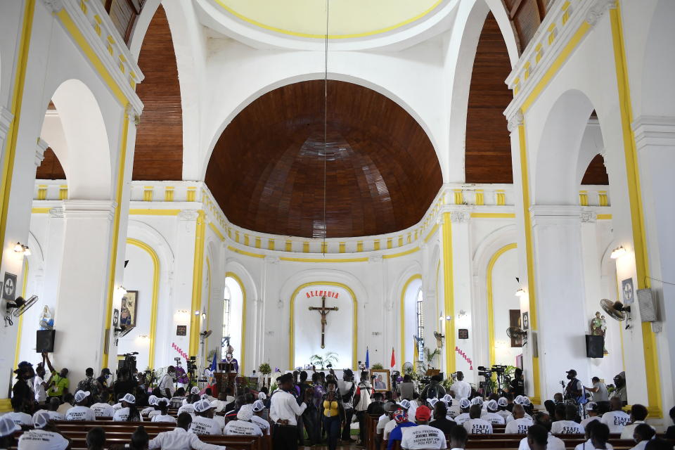 People attend a memorial service for assassinated President Jovenel Moïse in the Cathedral of Cap-Haitien, Haiti, Thursday, July 22, 2021. Moïse was killed in his home on July 7. (AP Photo/Matias Delacroix)