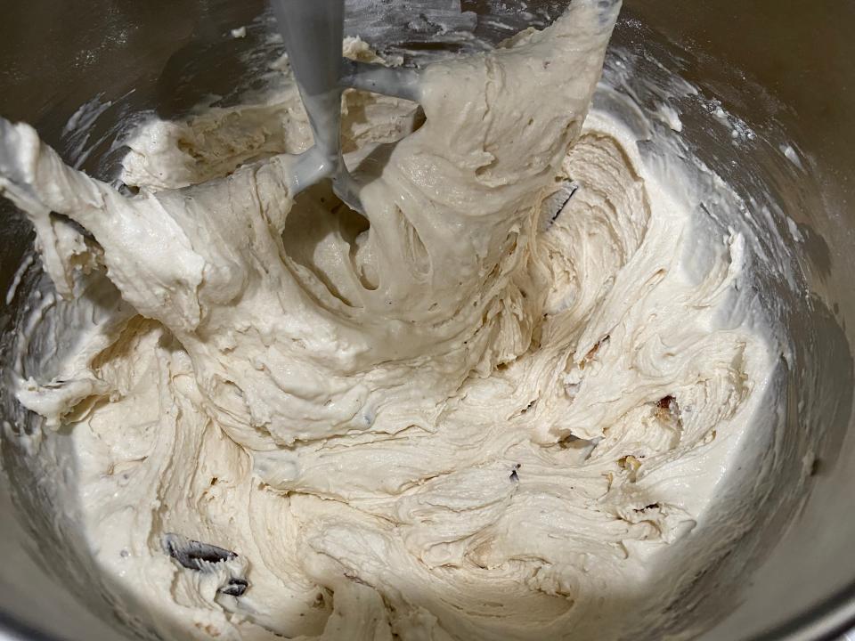 mixing the white and beige chunky monkey ice cream batter in the sand mixer