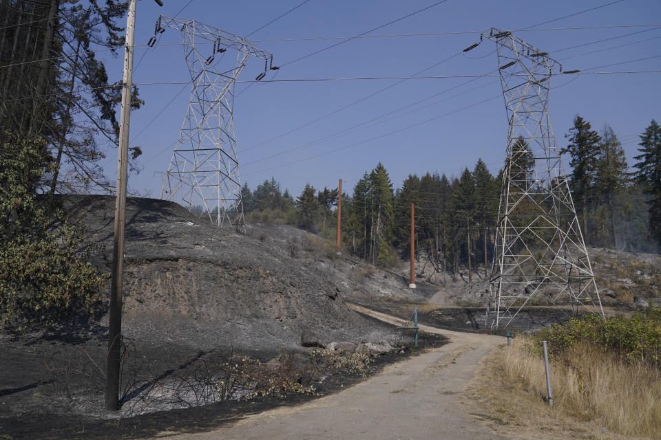 Land burned under power lines is shown, Wednesday, Sept. 9, 2020, during a media tour to survey wildfire damage in Bonney Lake, Wash., south of Seattle. (AP Photo/Ted S. Warren, Pool)