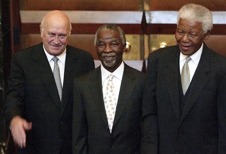 South African President Thabo Mbeki and former Presidents F.W. de Klerk (L) and Nelson Mandela (R) pose for photographers outside parliament in Cape Town, after Mbeki's election as president, in this May 10, 2004 file photo. REUTERS/Mike Hutchings/Files