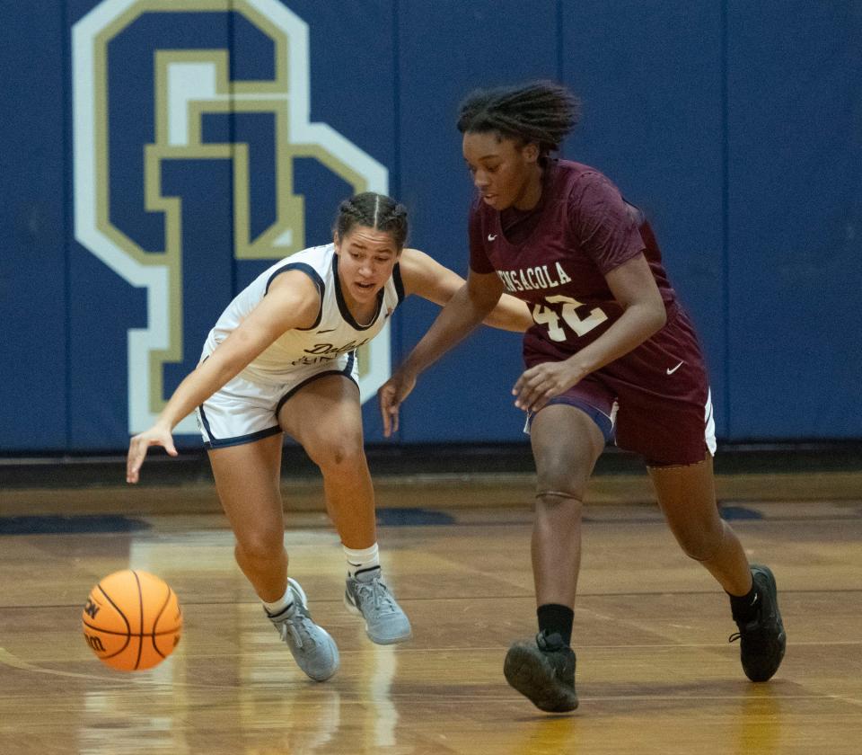 Gulf Breeze High School's Jayah Jones (No. 25) battles Pensacola High School's Aaleyah Jackson (No. 42) for basketball possession during Friday's home game against the visiting Tigers.