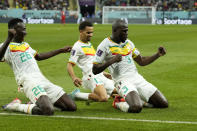 Senegal's Kalidou Koulibaly, right, celebrates with teammates scoring his side's second goal during the World Cup group A soccer match between Ecuador and Senegal, at the Khalifa International Stadium in Doha, Qatar, Tuesday, Nov. 29, 2022. (AP Photo/Francisco Seco)